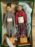 Pair of Nepalese carved wood figures in presentation box
