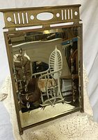 Front view showing brass frame and etched glass design