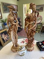 Front view of both figurines and jar