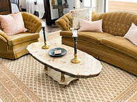Full view of marble-top cocktail table between sofas