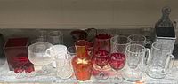 Full lot overview on shelf showing all glassware and wall pocket