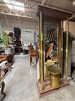 Floor mirror front view with brass columns and pedestal stool