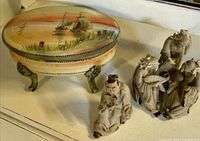 Overall lot showing Nippon covered dish and three mud men figurines