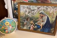 Clock and framed print side by side