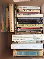 Box showing paperbacks and hardcovers including Dracula, Against the Grain, Beckett titles, Vasari On Technique