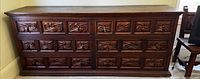 front view showing all carved drawer fronts and metal pulls
