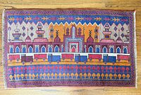 Full view of Afghan pictorial war rug on hardwood floor