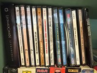 Row of jewel case CDs showing Leonard Cohen, assorted classical and pop titles