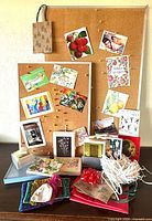 Overview of greeting cards pinned to boards, kraft bag hanging, gift wrap items and fabric pouches on table