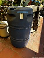 Front view of blue HDPE barrel showing ribbed sides and overall wear