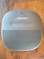 Front view showing grille, Bose logo, control buttons, overall wear