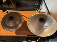 Two clamp reflector lamps, front reflectors visible
