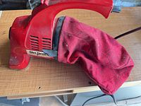 Left side view of Dirt Devil handheld vacuum showing body and dust bag