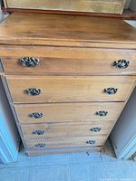 Front view showing five drawers and hardware