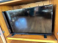 Front view of Insignia 39-inch LED TV on shelf
