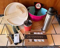 Group shot of all items: spinner lid, salad bowl, jar opener, knives, water bottle, tumbler, cork trivets, votive box