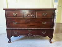Front view of Lane cedar chest showing drawers, carvings, legs