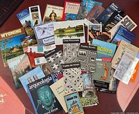 Overview of entire lot showing assortment of booklets, maps and postcards