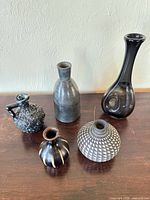 Group shot of all five vases on wooden surface