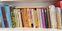 Shelf view of numerous theatre and literature paperbacks