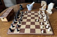 Overall lot showing chess set, mortar & pestle, stone knight bookends, wood block game