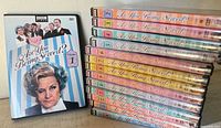 Stack of BBC "Are You Being Served?" Vols 1-14 DVDs with Volume 1 case front displayed