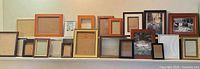 Shelf view of approximately 20 frames of differing sizes and finishes