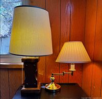 Wood and brass lamps with shades lit