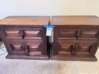 Front view of both nightstands showing carved panels and hardware
