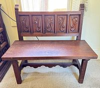 Front view of carved solid wood bench