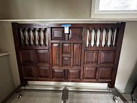 Front view of wood headboard showing panel and baluster details