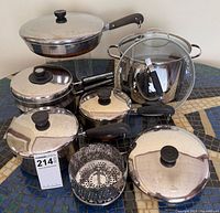 Group shot showing entire cookware set with lids and steamer basket