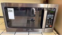 Front view of Toshiba EM131A5C-BS microwave showing door, control panel and overall exterior condition