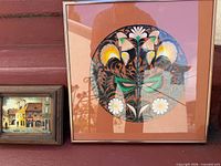 Both framed artworks side by side showing relative sizes
