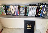 Full upper shelf showing majority of VHS tapes