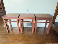 front view of three matching solid wood tables