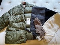 Jacket laid out with scarves and gloves