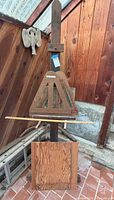 Front view of tall studio easel assembled with triangular canvas holder and lower shelf