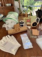 Assorted jewelry display pieces, poly bags, bubble wrap, gloves, stickers on table