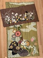 Both textile wall hangings laid out together
