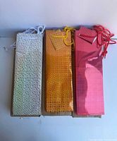 Front view of three types of gift bags showing colors and patterns