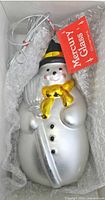 Snowman ornament in box showing details and tag