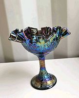 Side view of purple iridescent Fenton Persian Medallion ruffle compote