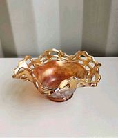 Side view showing ruffled rim and bowl shape