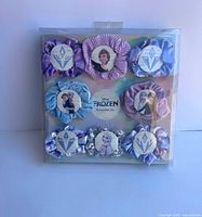 Front of sealed box showing eight scrunchies surrounding Frozen logo