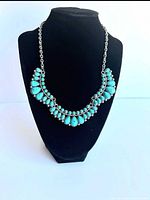 Front view showing turquoise-color cabochon design