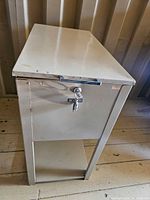 Front view showing closed cabinet with lock and key