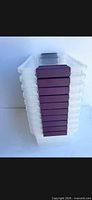 Stack of ten translucent Sterilite bins showing purple latch ends