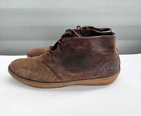 Side view Timberland brown leather chukka boots showing overall design and embossed logo