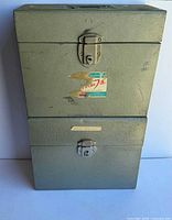 Both metal filing boxes stacked showing front latches and overall wear